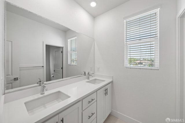 bathroom featuring plenty of natural light, tile patterned flooring, and vanity