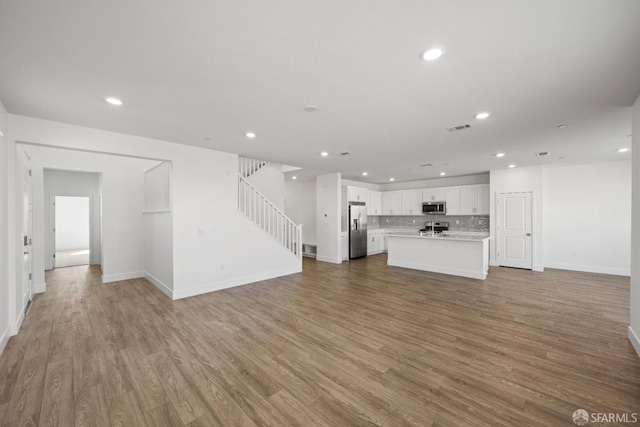 unfurnished living room featuring light hardwood / wood-style floors