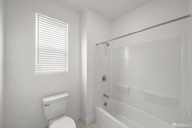 bathroom featuring tile patterned floors, shower / bathtub combination, and toilet