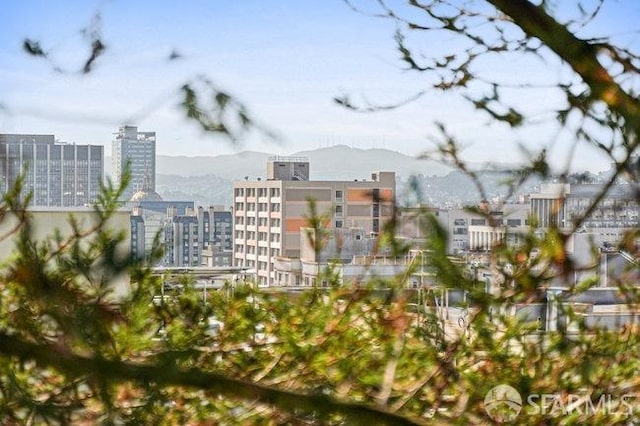 exterior space featuring a mountain view and a city view