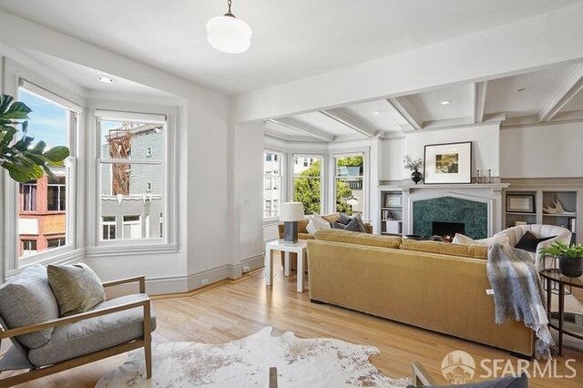 living room with beamed ceiling, recessed lighting, wood finished floors, a high end fireplace, and baseboards