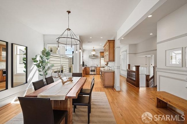 dining space featuring light wood-style flooring, a healthy amount of sunlight, and recessed lighting