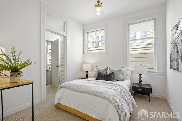 carpeted bedroom featuring baseboards