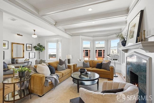living area with a premium fireplace, crown molding, beamed ceiling, and visible vents