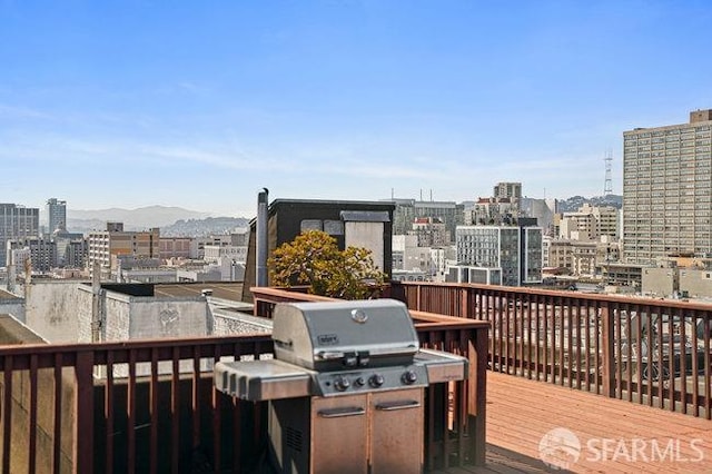 deck with area for grilling and a view of city