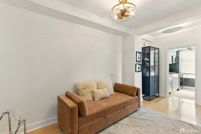 631 Ofarrell St Unit 702, San Francisco, CA 94109 - living area with light wood-type flooring, baseboards, and a chandelier