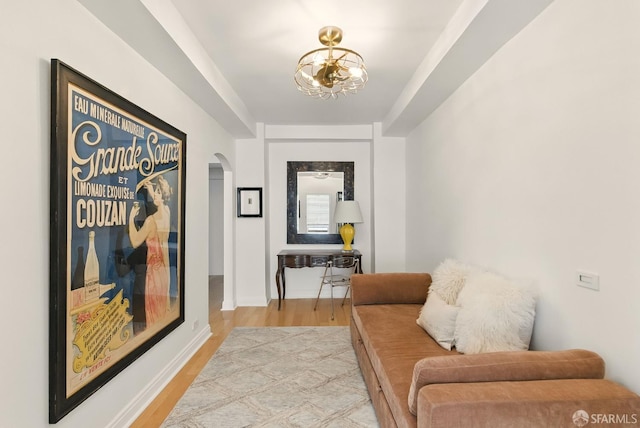 631 Ofarrell St Unit 702, San Francisco, CA 94109 - sitting room featuring arched walkways, light wood finished floors, and a chandelier