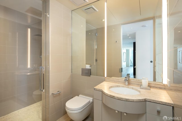 bathroom featuring tile walls, an enclosed shower, vanity, and toilet