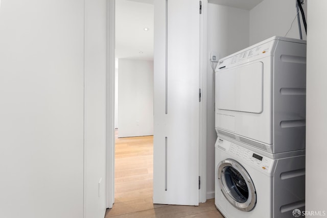 181 Fremont St Unit 58A, San Francisco, CA 94105 - washroom with stacked washer and clothes dryer and light wood-style floors