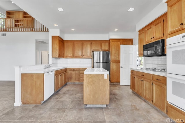 4737 Crestone Peak Dr, Antioch, CA 94531 - kitchen featuring backsplash, stainless steel appliances, light countertops, and a center island