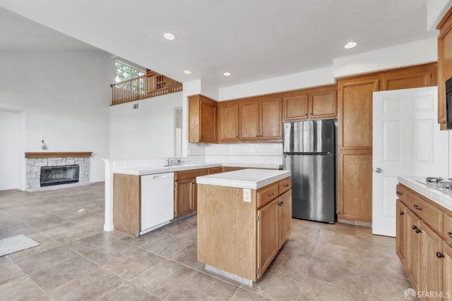 4737 Crestone Peak Dr, Antioch, CA 94531 - kitchen featuring decorative backsplash, a kitchen island, white dishwasher, light countertops, and freestanding refrigerator