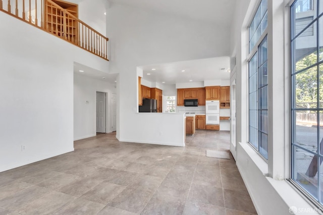4737 Crestone Peak Dr, Antioch, CA 94531 - unfurnished living room with baseboards, a high ceiling, and recessed lighting