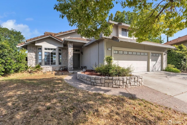 4737 Crestone Peak Dr, Antioch, CA 94531 - view of front of house with an attached garage, driveway, a tiled roof, and stone siding