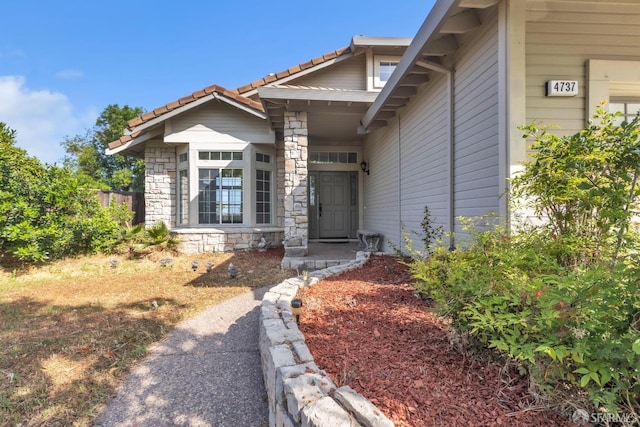 4737 Crestone Peak Dr, Antioch, CA 94531 - view of exterior entry with a tile roof and stone siding