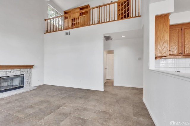 4737 Crestone Peak Dr, Antioch, CA 94531 - unfurnished living room featuring a fireplace, baseboards, visible vents, and a towering ceiling