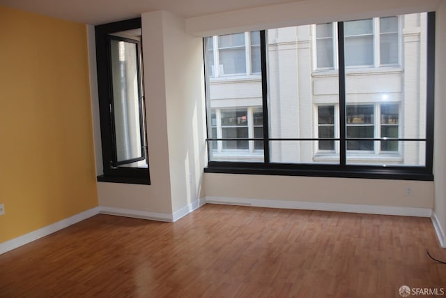 unfurnished room featuring hardwood / wood-style floors