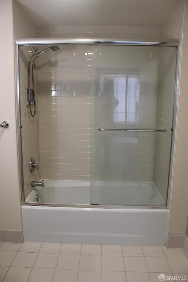 bathroom featuring enclosed tub / shower combo and tile patterned flooring