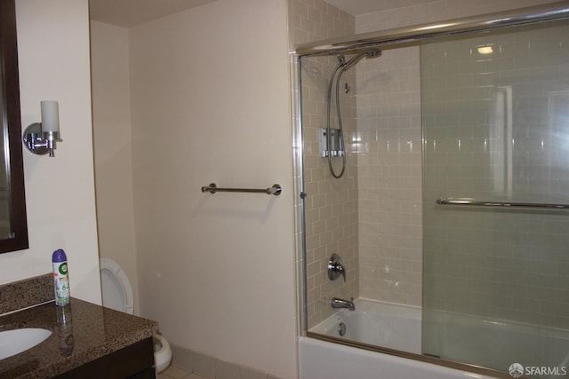 full bathroom with vanity, toilet, tile patterned floors, and bath / shower combo with glass door