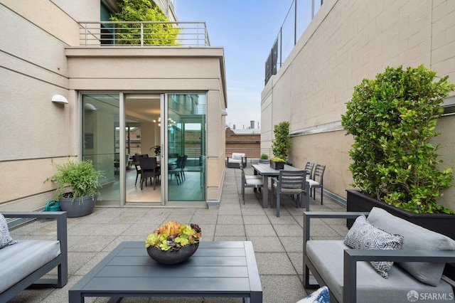 view of patio with a balcony and outdoor lounge area