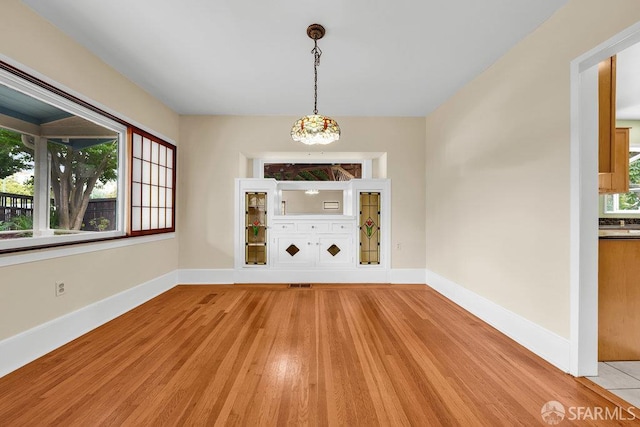 3779 Park Boulevard Way, Oakland, CA 94610 - unfurnished dining area with baseboards and light wood-style floors
