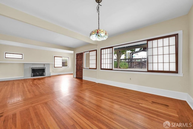 3779 Park Boulevard Way, Oakland, CA 94610 - unfurnished living room featuring plenty of natural light, wood finished floors, a brick fireplace, and a chandelier
