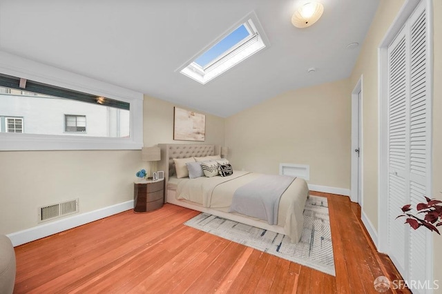 3779 Park Boulevard Way, Oakland, CA 94610 - bedroom with wood finished floors, vaulted ceiling, a skylight, and a closet