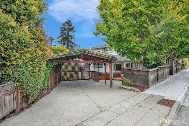 3779 Park Boulevard Way, Oakland, CA 94610 - view of patio / terrace featuring a fenced front yard, a carport, and driveway