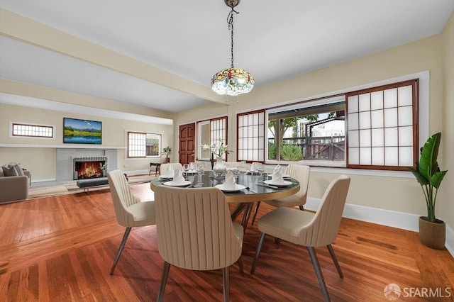 3779 Park Boulevard Way, Oakland, CA 94610 - dining area featuring healthy amount of natural light, a brick fireplace, and wood finished floors