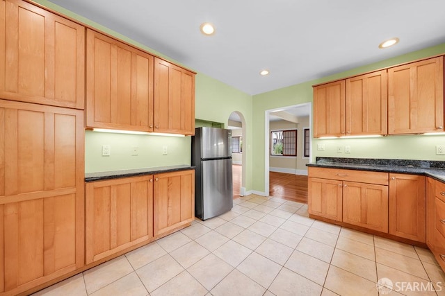 3779 Park Boulevard Way, Oakland, CA 94610 - kitchen with freestanding refrigerator, light tile patterned flooring, arched walkways, and recessed lighting