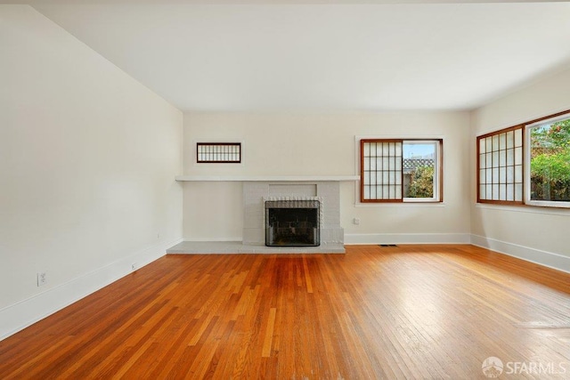 3779 Park Boulevard Way, Oakland, CA 94610 - unfurnished living room with wood finished floors and a brick fireplace