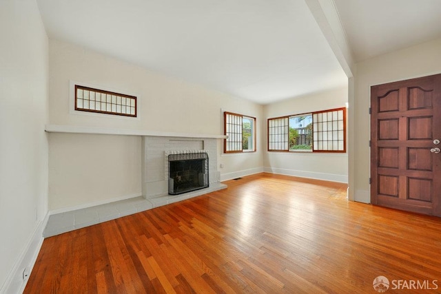 3779 Park Boulevard Way, Oakland, CA 94610 - unfurnished living room featuring wood finished floors and a brick fireplace
