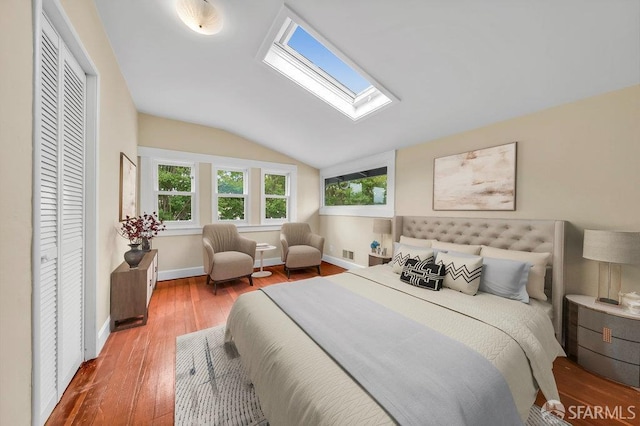 3779 Park Boulevard Way, Oakland, CA 94610 - bedroom featuring a skylight, vaulted ceiling, multiple windows, and wood finished floors