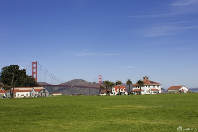 surrounding community featuring a mountain view and a yard