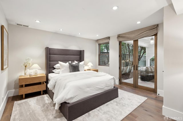 bedroom with visible vents, access to outside, wood finished floors, recessed lighting, and baseboards