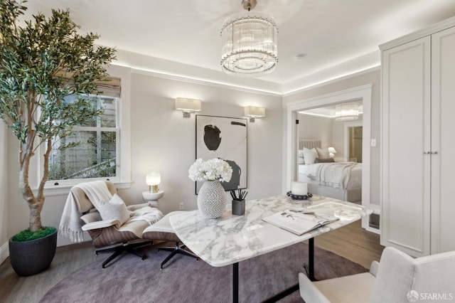 living room with an inviting chandelier and wood finished floors