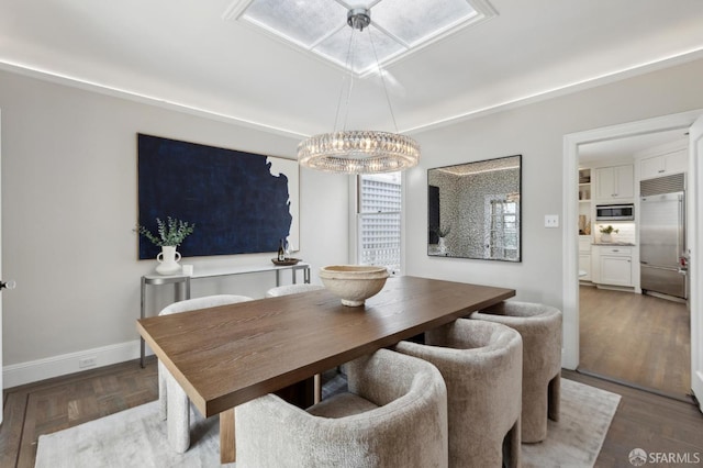 dining area featuring baseboards and wood finished floors