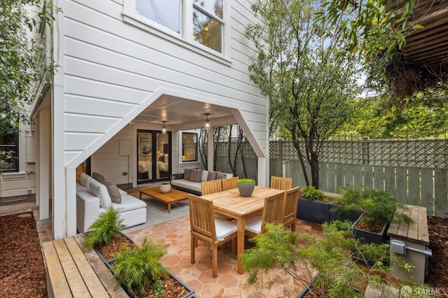 view of patio with an outdoor living space and fence