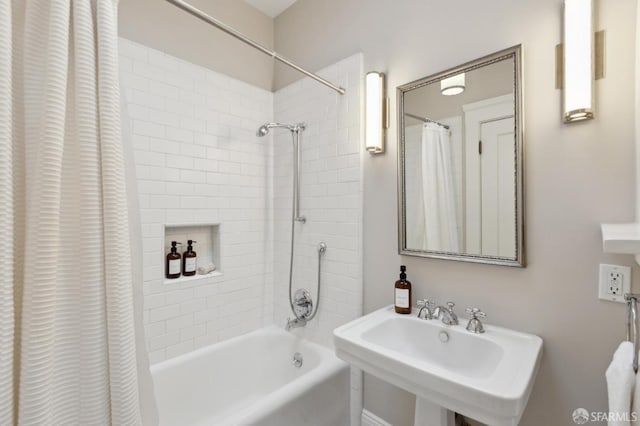 bathroom featuring a sink and shower / bath combo with shower curtain