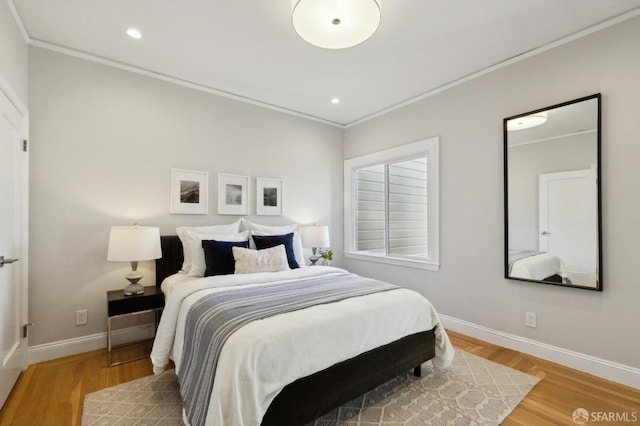 bedroom with light wood-type flooring and ornamental molding