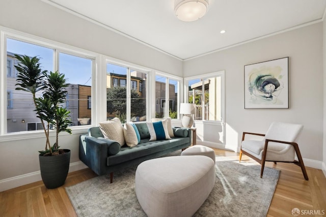 living room featuring light hardwood / wood-style floors and ornamental molding