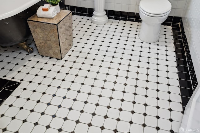 bathroom with tile patterned flooring and toilet