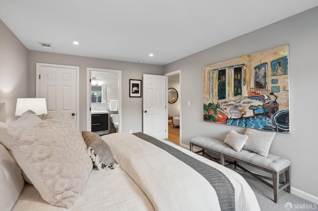 carpeted bedroom with ensuite bathroom