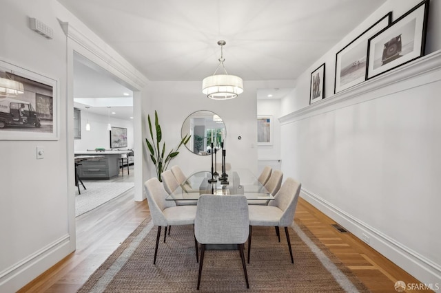 dining space featuring wood-type flooring