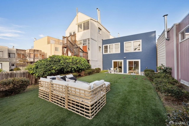 rear view of house with an outdoor living space and a yard