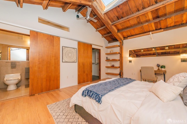 bedroom featuring wood ceiling, vaulted ceiling with skylight, and light hardwood / wood-style flooring