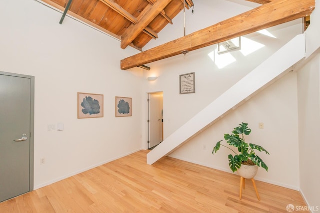 interior space with beamed ceiling, hardwood / wood-style floors, wood ceiling, and high vaulted ceiling