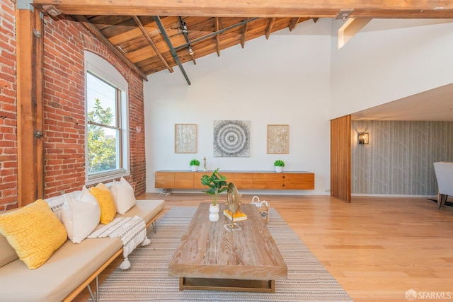 living room with wood-type flooring, brick wall, wooden ceiling, and beam ceiling