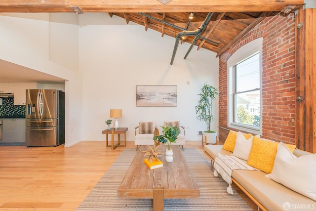 unfurnished living room with hardwood / wood-style flooring, wooden ceiling, high vaulted ceiling, and beam ceiling