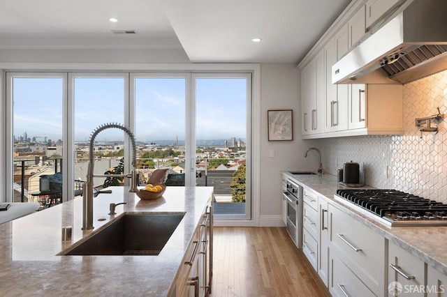1758 Palou Ave, San Francisco, CA 94124 - kitchen featuring under cabinet range hood, a sink, appliances with stainless steel finishes, backsplash, and crown molding
