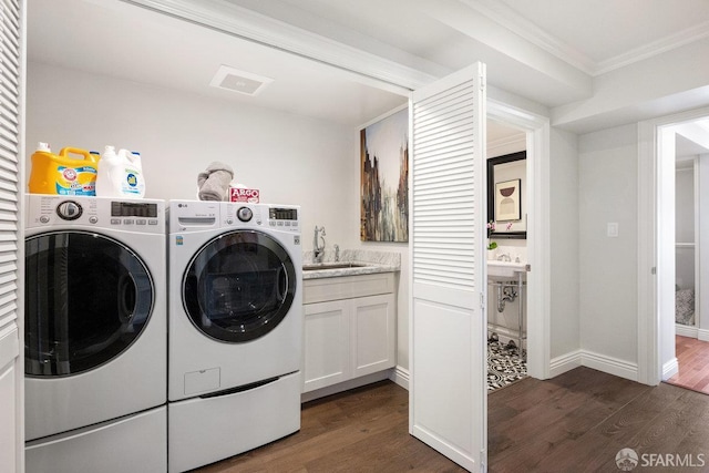 1758 Palou Ave, San Francisco, CA 94124 - laundry room featuring washing machine and clothes dryer, ornamental molding, dark wood finished floors, baseboards, and cabinet space